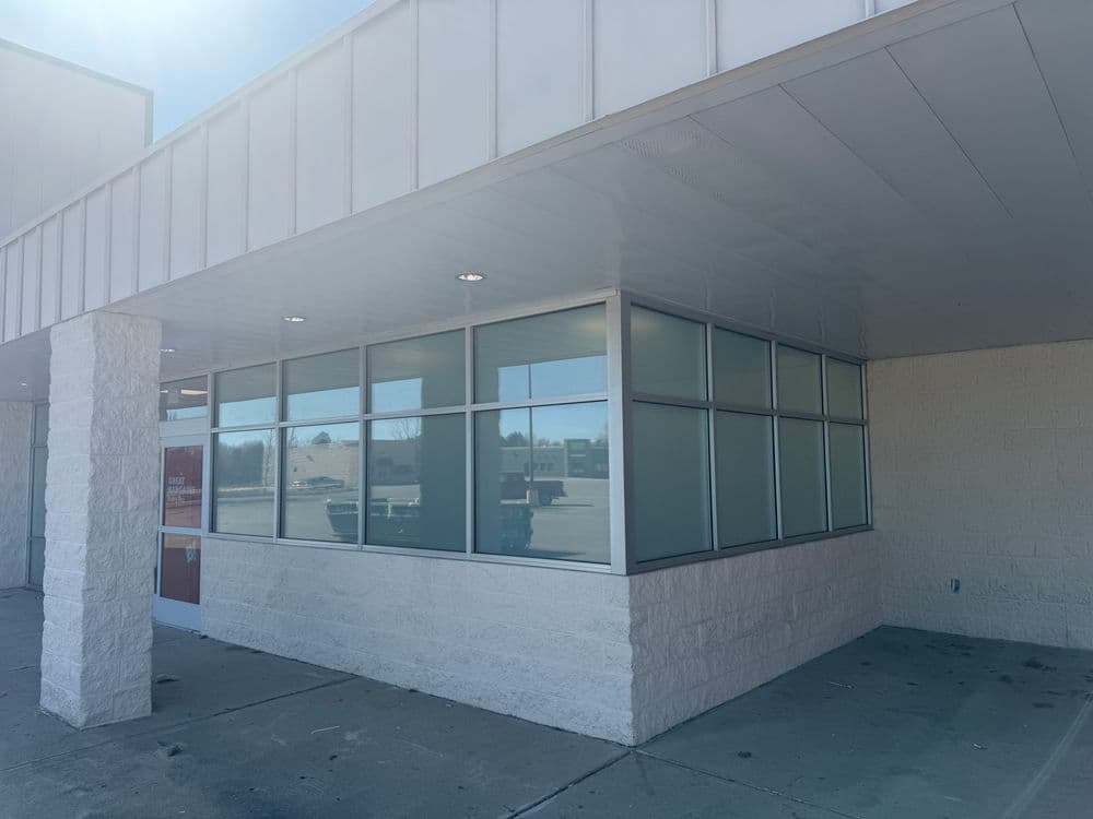 Exterior view of a commercial building with large windows and a modern design.
